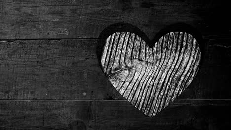 Animation-of-heart-shape-cut-in-wood,-with-moving-wood-grain-pattern,-black-and-white
