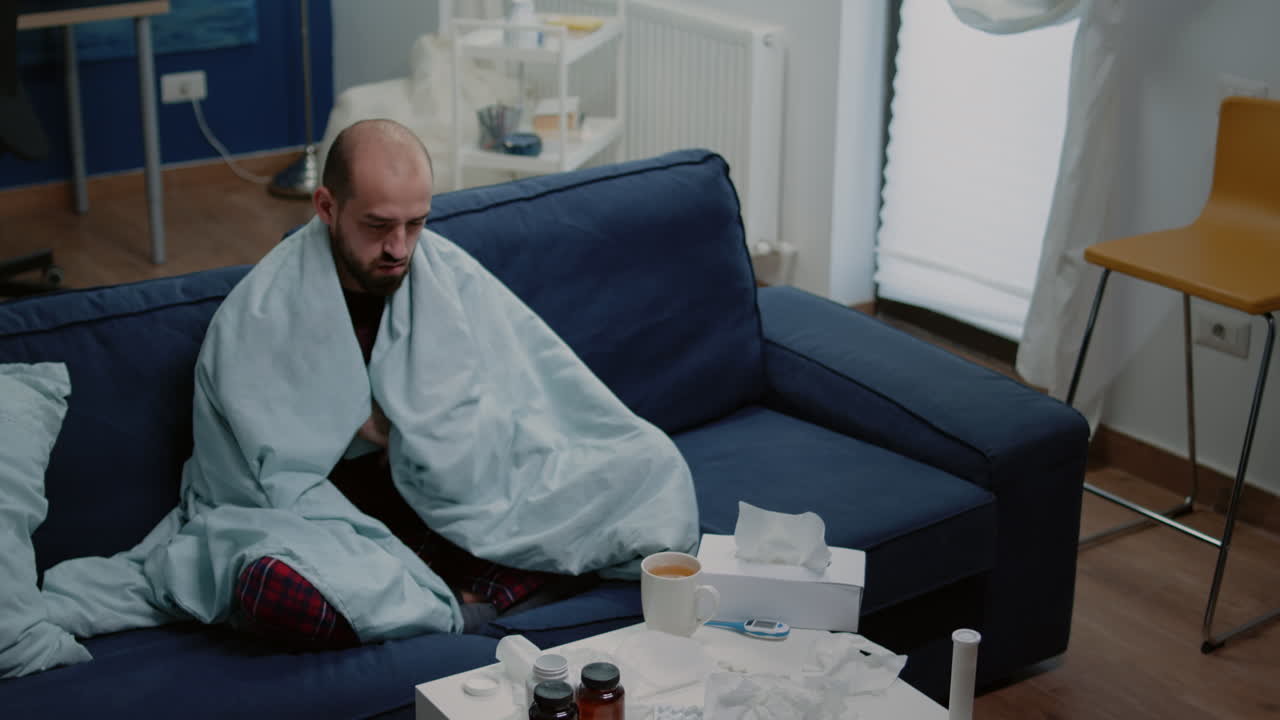 Person with sickness looking at tablets of capsules