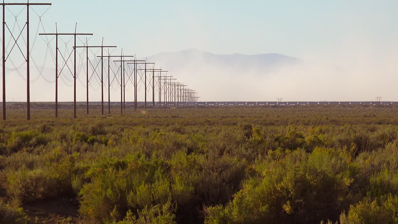 A train travels in the distance across a desert 1