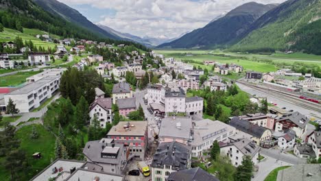 aerial flying over samedan town in the municipality in the maloja region in the swiss canton of grisons