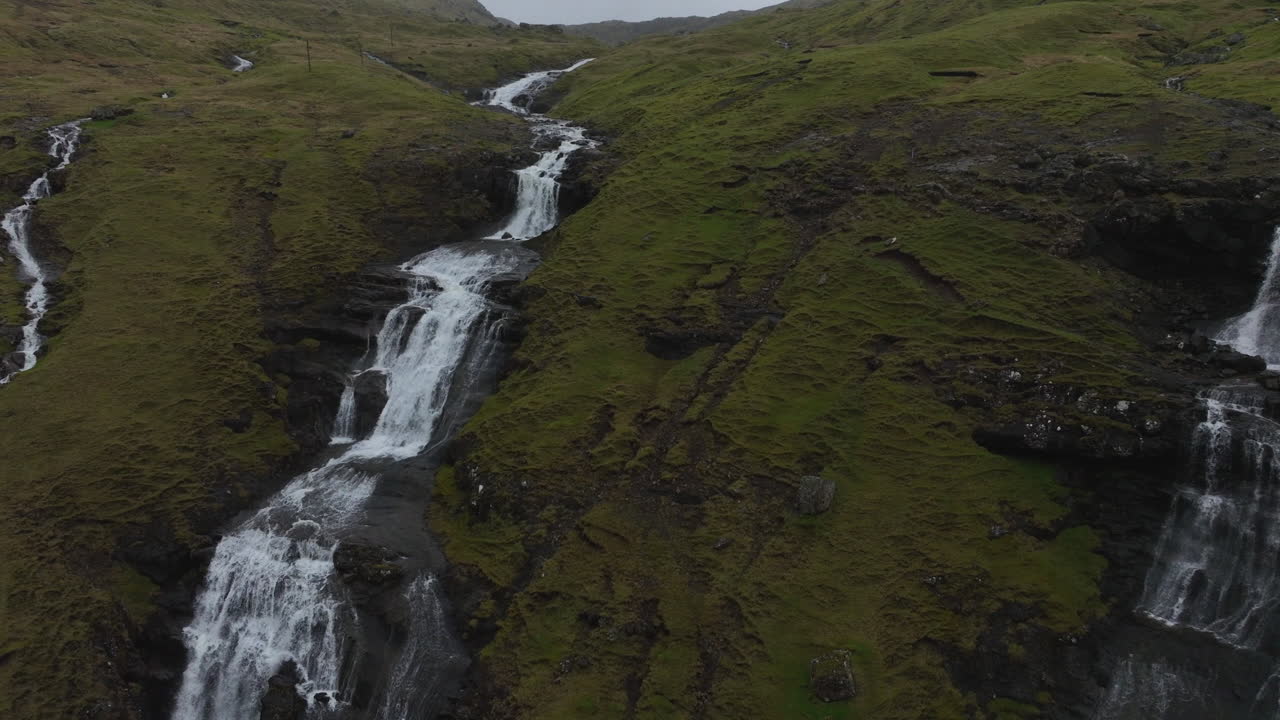 Oyggjarvegur mountain, Faroe Islands: close aerial view traveling in to the waterfalls of this great mountain, near the Kaldbaksfj&oslash;r&eth;ur fjord