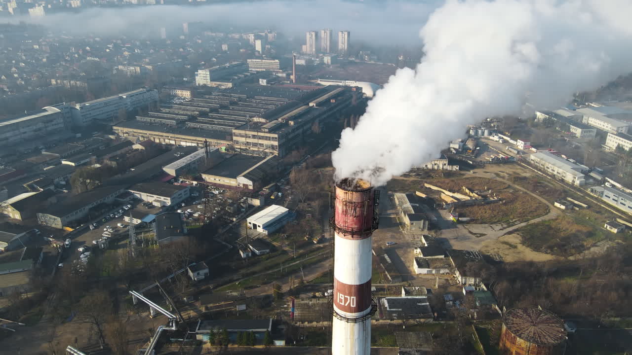 Aerial drone view of Chisinau. Thermal station with smoke coming out of the tube. Buildings, roads. Fog in the air. Moldova