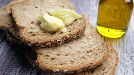 slices of whole wheat bread with butter and olive oil