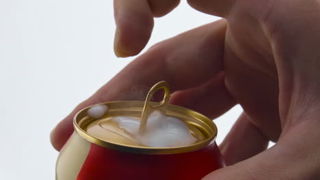 man opening beer can in super slow motion closeup. foam pouring out from canakin