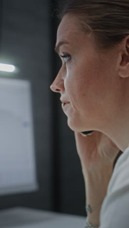 female financial analyst talking on phone, suffering from financial crisis, analyzing exchange market charts on computer and digital tablet. businesswoman angry about stock market crash. vertical shot