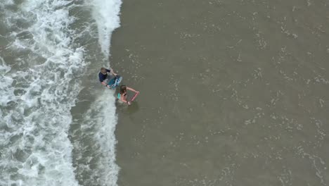 kids body boarding at ventura, california beach