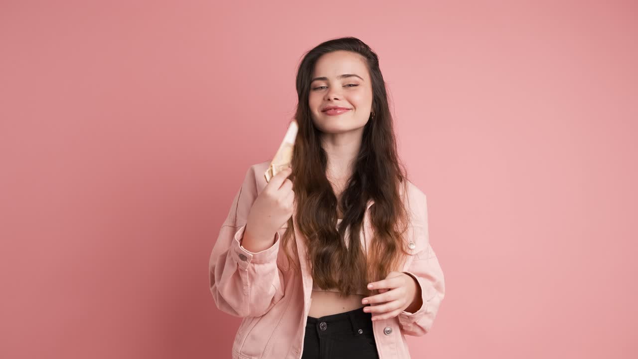 Rich woman counting euro banknotes in pink studio