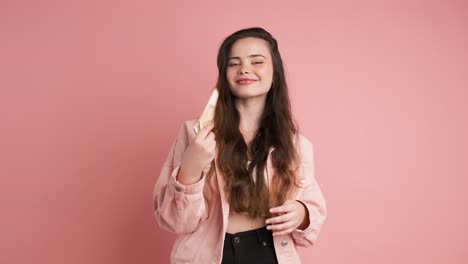 rich woman counting euro banknotes in pink studio