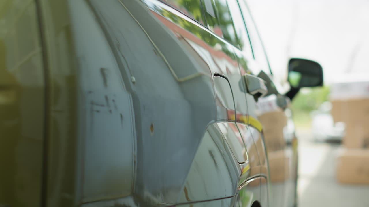 Man Charging Electric Car On Driveway Before Leaving For Work