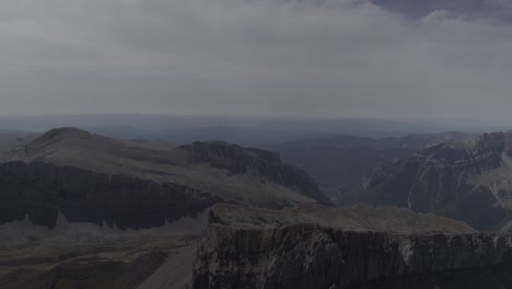 this drone video features a stunning frontal descriptive shot flying over the majestic mountains of pico del castillo d’acher in the aragonese pyrenees, spain, showcasing breathtaking natural beauty.