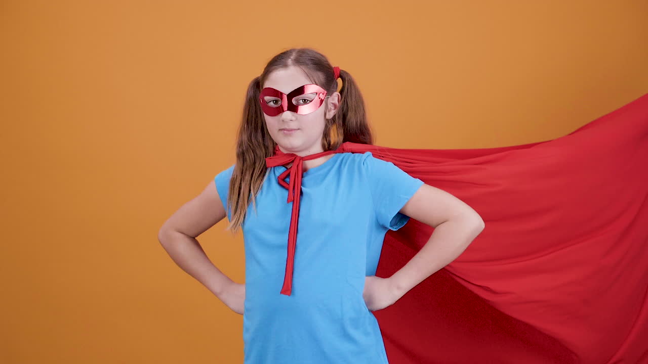 Girl in Superhero Costume with Cape and Mask