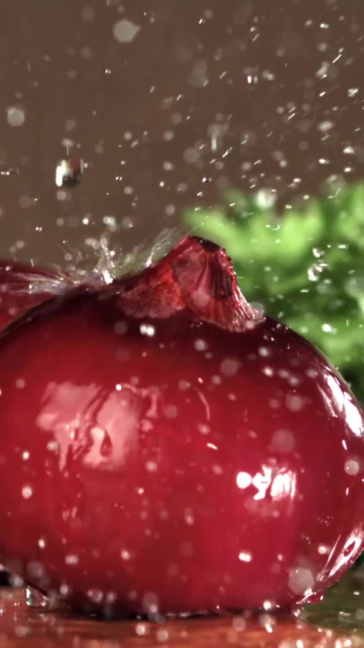 Slow Motion Water Splashing on a Fresh Red Onion