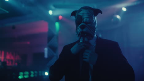 masked man in a suit at a nightclub