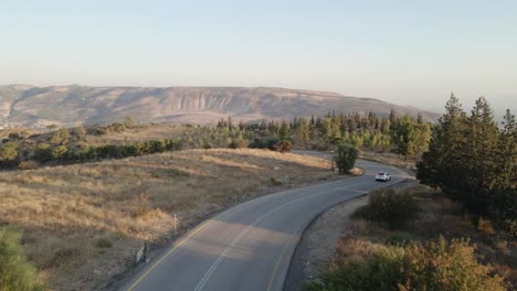 Car-driving-alone-on-rural-road-in-Mevo-Hama-forest