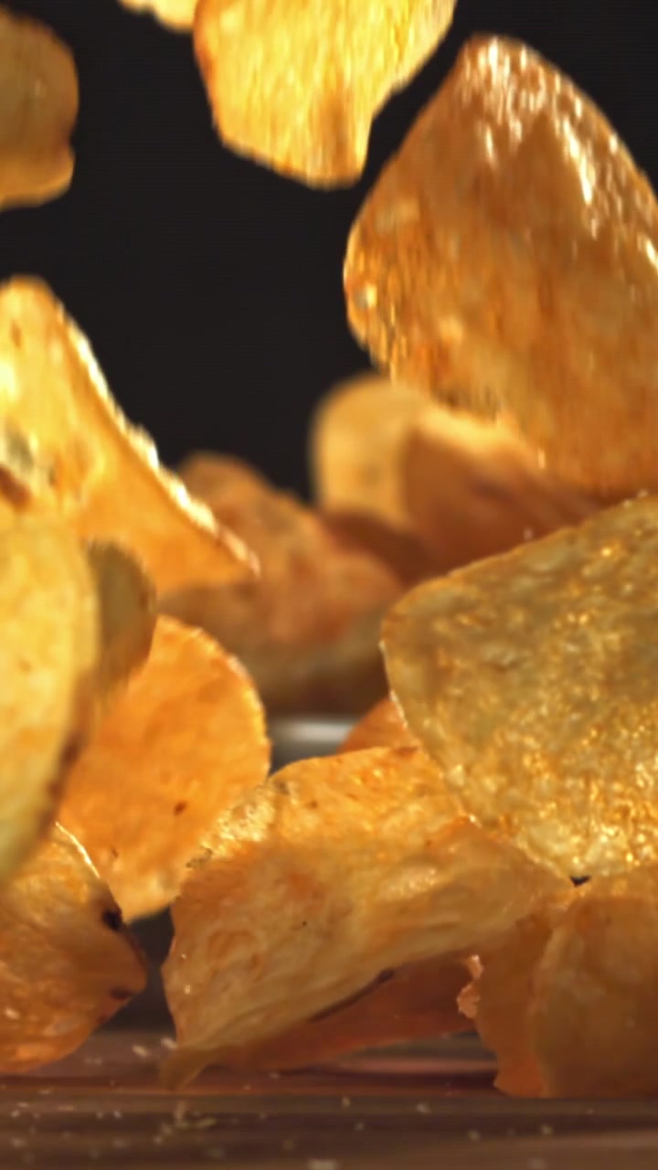 Crispy Golden Potato Chips Falling in Slow Motion
