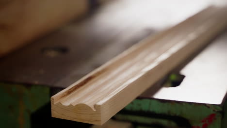 wood plank being planed on a woodworking machine