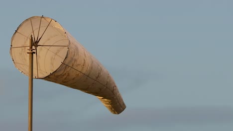a detailed view of a windsock gently swaying against a clear sky.