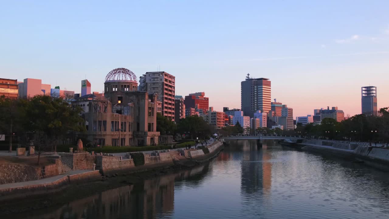 Atomic bomb dome and Hiroshima skyline at sunset from Aioi bridge.