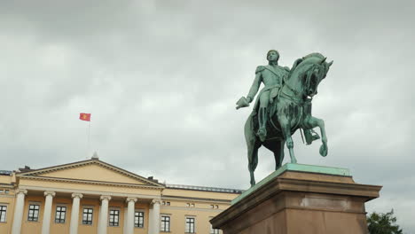 statue of king carl xiv johan in oslo norway in the background is seen the royal palace steadicam sh