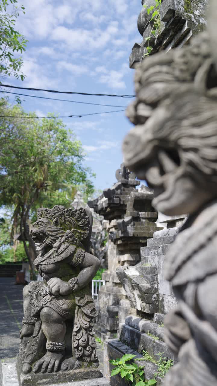 Money face stone statue in Bali island, close up vertical view
