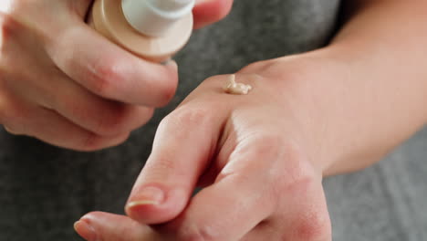 woman applying foundation on wrist