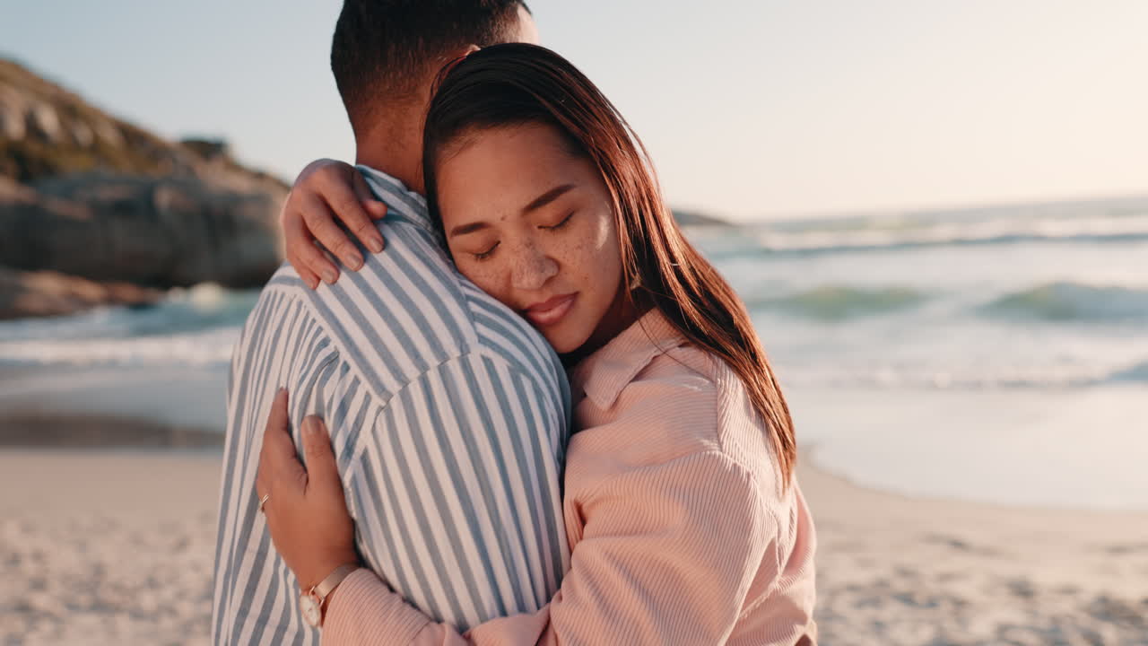 Love, sunset and couple hugging at the beach