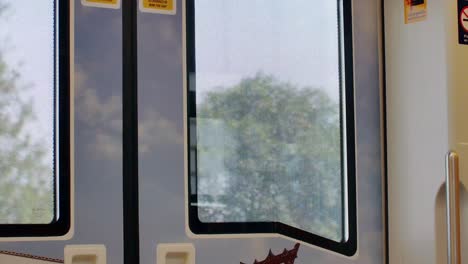view from inside skytrain -public transportation in bangkok. outside view from the window on the train's door