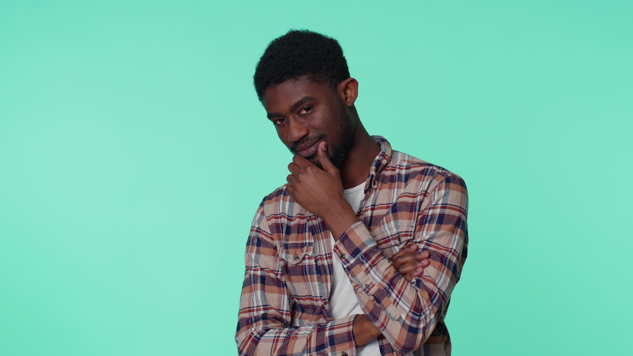Smiling playful happy man blinking eye, looking at camera with toothy smile, winking and flirting