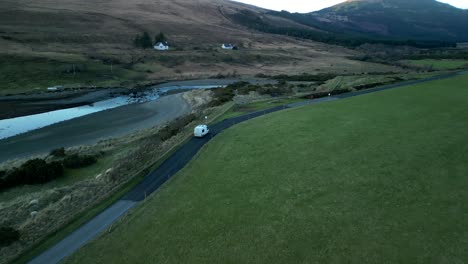 Tracking-van-on-Scottish-Highland-road-with-reveal-of-sunset-colours-at-Glenbrittle-Isle-of-Skye-Scotland