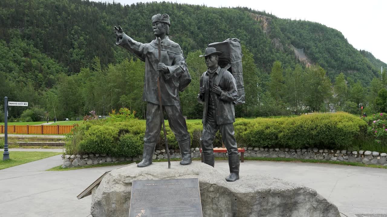 Skagway Centennial Statue is located in Skagway Centennial Park, Alaska.Depicting a Tlingit packer showing the way to a prospector.