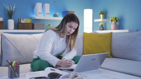 College-student-girl-happily-studying-at-home.