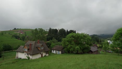 green village landscape with church and houses among lush trees on overcast day