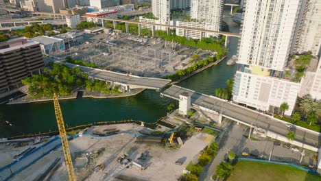 bascule bridge over river in city. opening of bridge for yacht passage. tilt up reveal high rise buildings in background. miami, usa