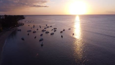 perfect sun set on the coastline going over boats