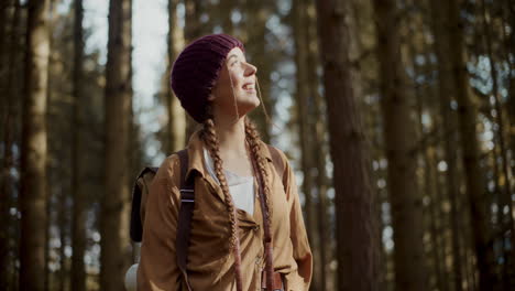 young woman wearing knitted hat in forest