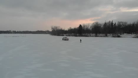 skiing on ice pulled by a truck