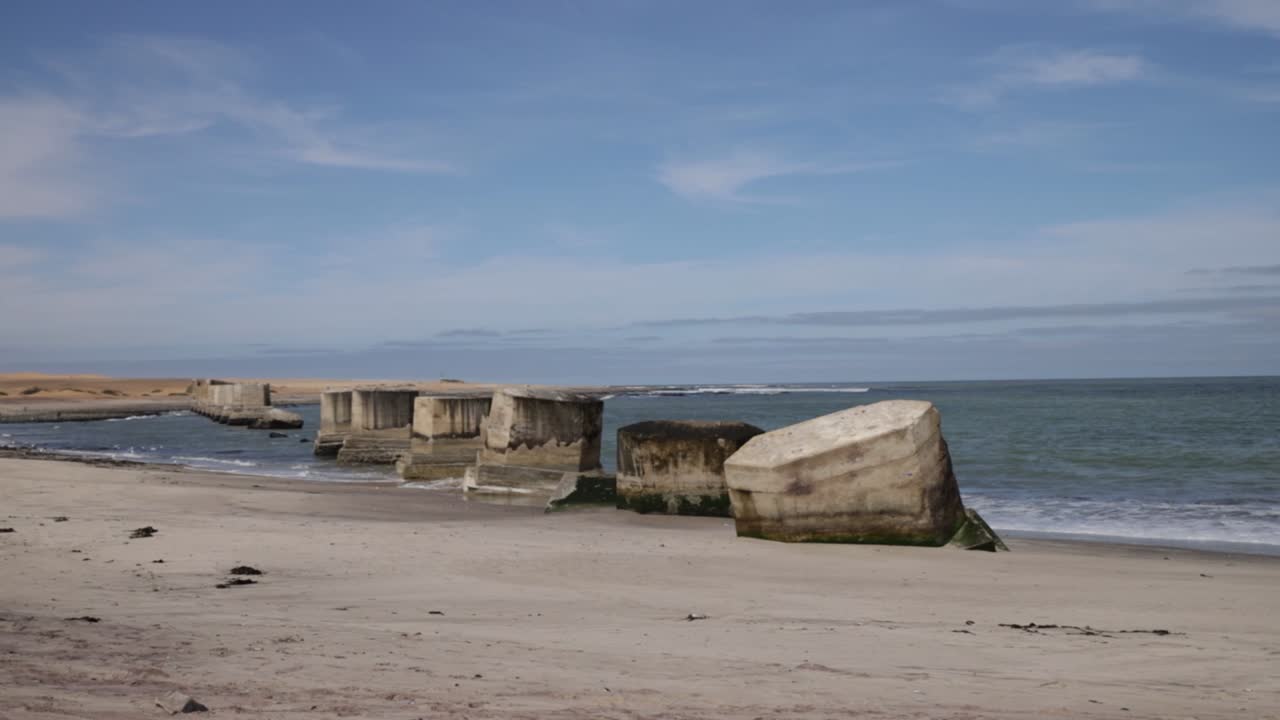 Abandoned bridge pylons on Swakopmund's beach in Namibia