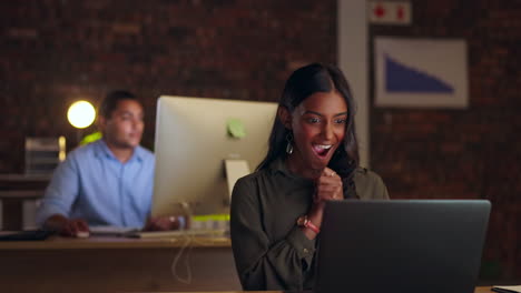 Winner,-laptop-and-Indian-woman-in-office-at-night