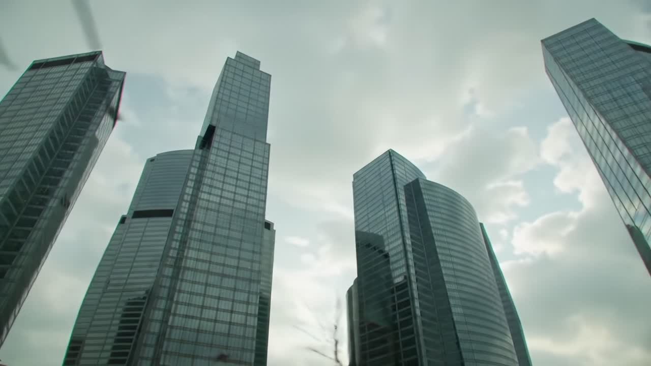 A Majestic Skyline: Captivating Views of Modern Skyscrapers Reaching Towards the Clouds Under a Dramatic Sky on a Vibrant Day in the City