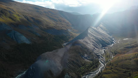 Majestic Mountain Valley with River and Sun Flare