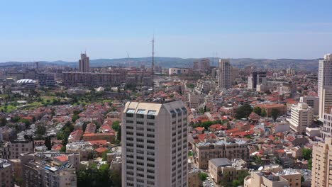 aerial view of a bustling cityscape with a prominent skyscraper