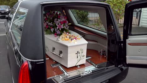 closeup shot of a funeral casket in a hearse or chapel or burial at cemetery