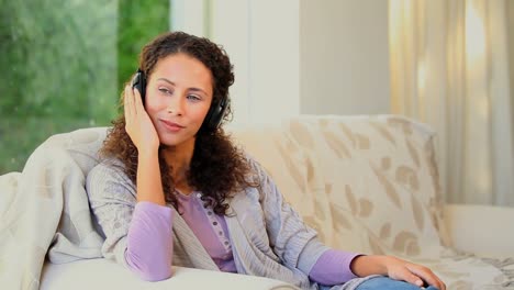 young woman listening to music with headphones