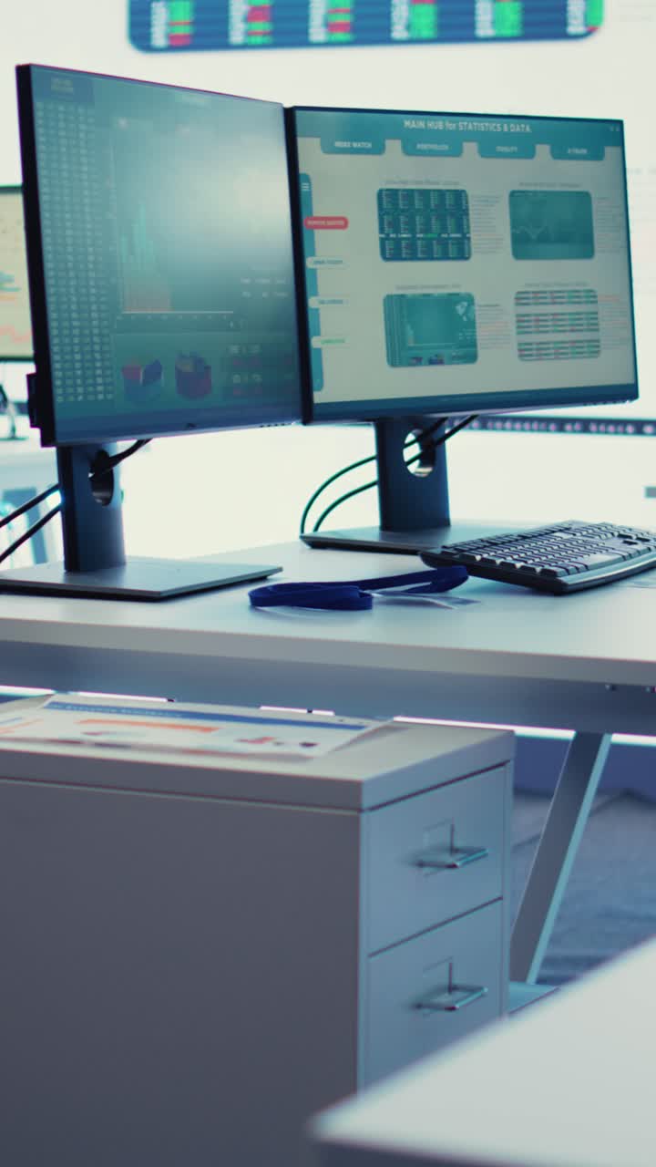 Empty Office with Computer Monitors Displaying Financial Data