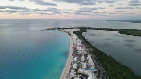 stunning aerial view of cancun coastline, showcasing clear turquoise waters and resort buildings, playa delfines