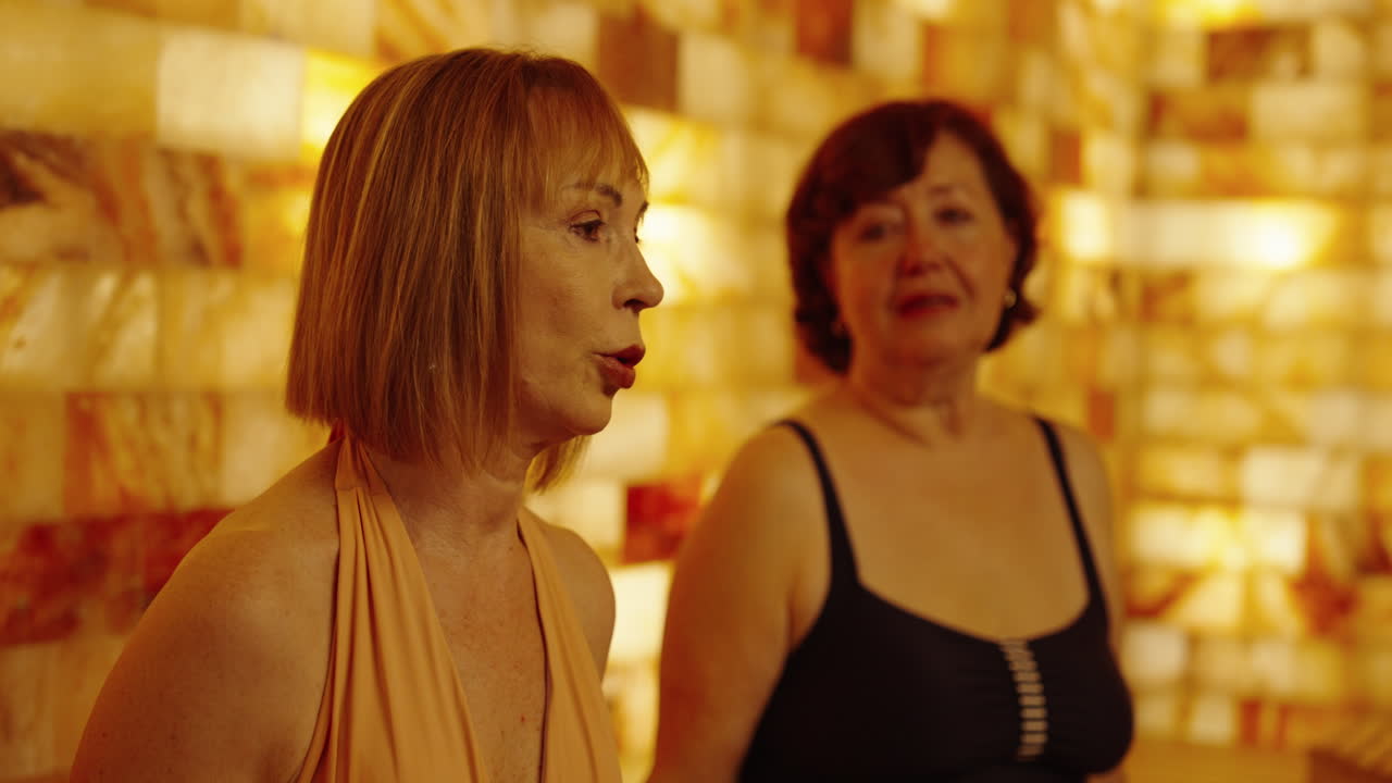 Two women relaxing in a salt room spa