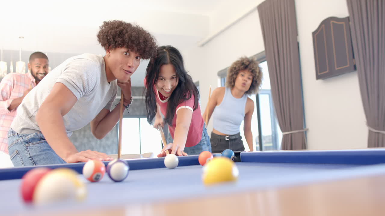 Playing pool, Diverse friends enjoying fun hangout indoors