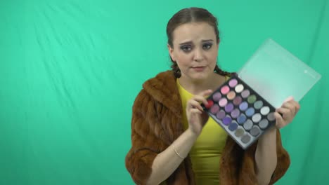 Gorgeous-Woman-Choosing-Eyeshadow-Shade-In-A-Makeup-Palette---medium-shot