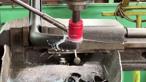 Milling machine is cuting the irone plate pipe using coolant liquid