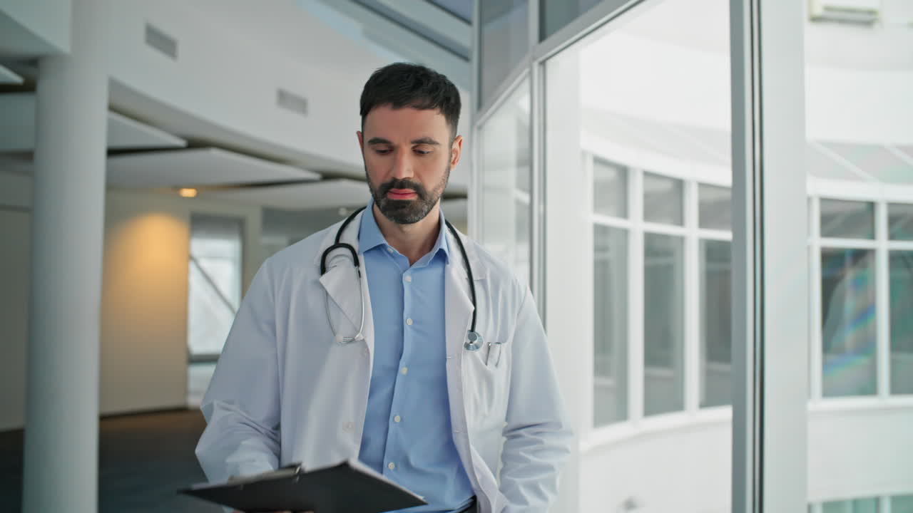 Serious therapist looking diagnosis clipboard. Closeup upset doctor walking